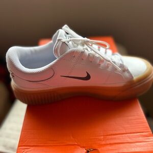 Nike Women’s White Leather Sneakers with Gum Sole and Black Swoosh